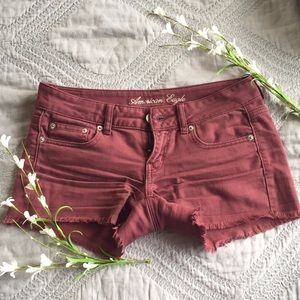 American Eagle frayed maroon jean shorts